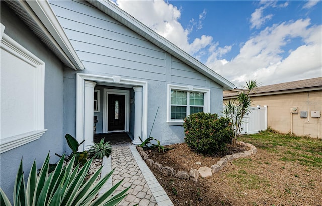 entrance to property with stucco siding