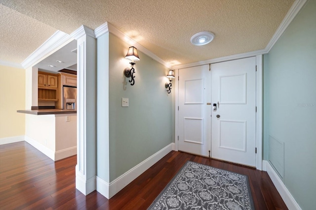 interior space with crown molding, dark hardwood / wood-style floors, and a textured ceiling