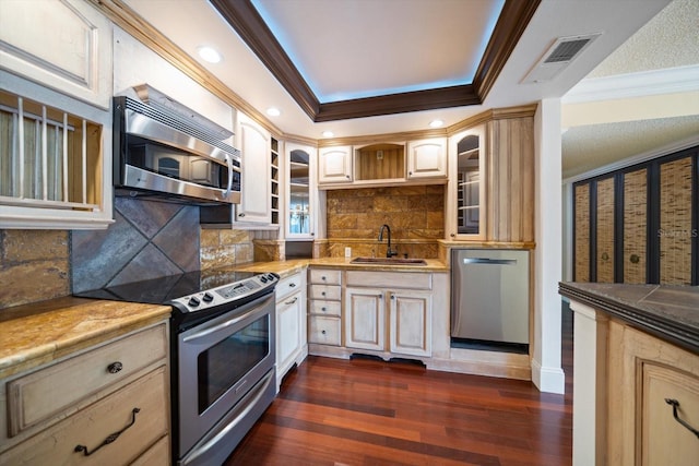 kitchen with dark hardwood / wood-style floors, sink, decorative backsplash, ornamental molding, and stainless steel appliances