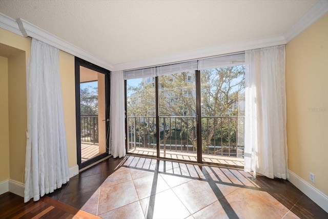 interior space with crown molding, plenty of natural light, and dark tile patterned floors