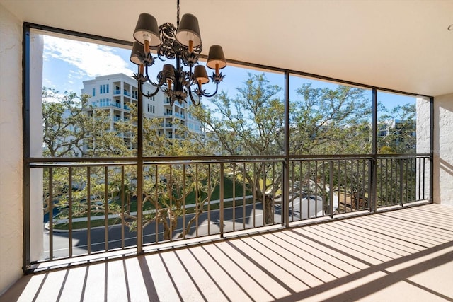 unfurnished sunroom with a chandelier