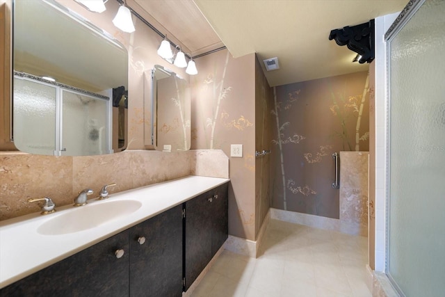 bathroom with tasteful backsplash, vanity, and an enclosed shower