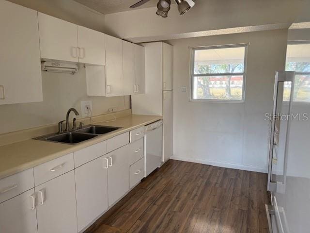 kitchen featuring dishwasher, white cabinetry, sink, and dark hardwood / wood-style flooring