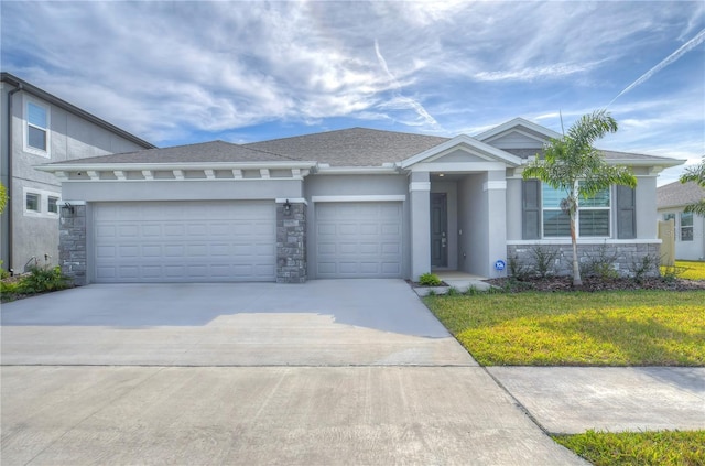 view of front of property featuring a garage and a front yard