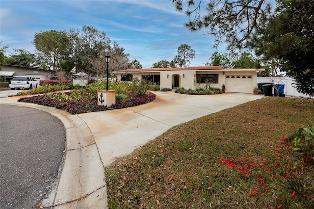 ranch-style house with a garage and a front lawn