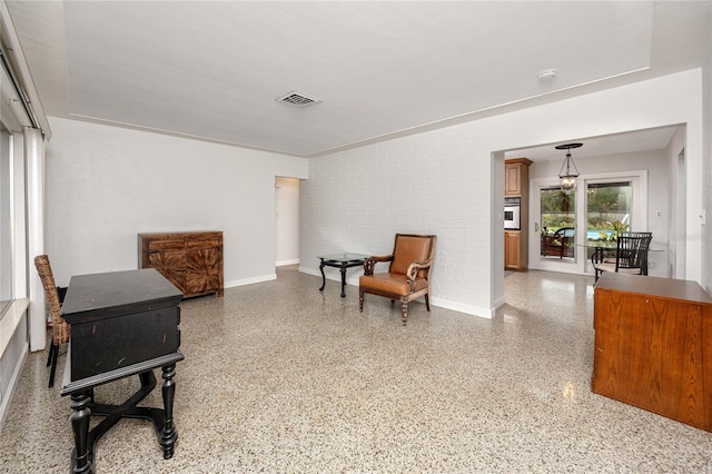 sitting room with brick wall