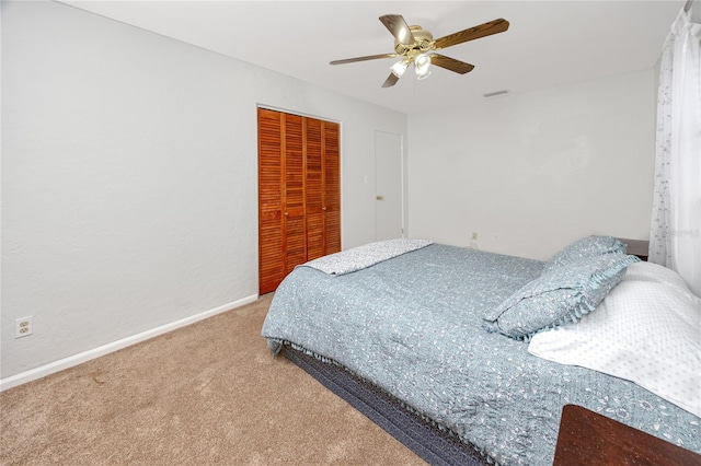 bedroom with ceiling fan, a closet, and carpet