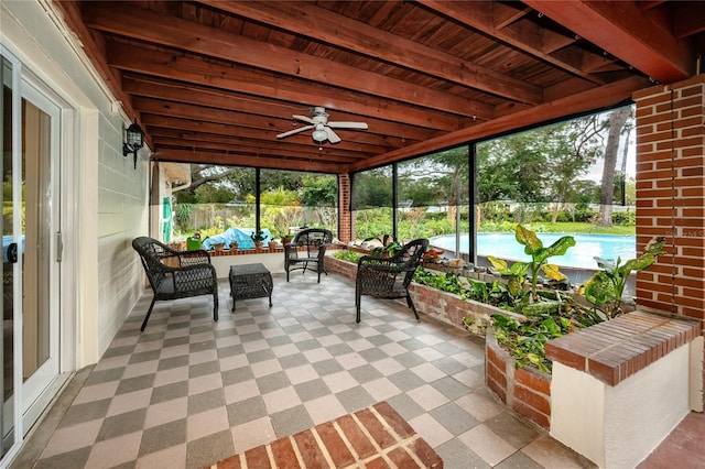 sunroom / solarium with beam ceiling, wooden ceiling, and ceiling fan