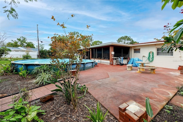 view of patio with a sunroom