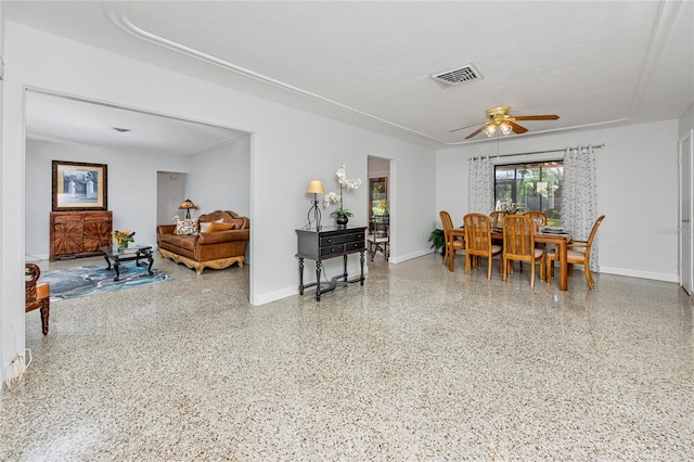 dining area featuring a ceiling fan, visible vents, baseboards, and speckled floor