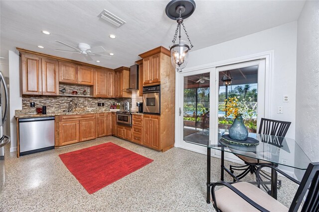 kitchen with appliances with stainless steel finishes, visible vents, decorative light fixtures, and a ceiling fan