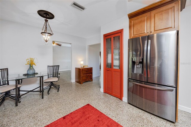 kitchen with baseboards, visible vents, stainless steel fridge with ice dispenser, brown cabinets, and speckled floor