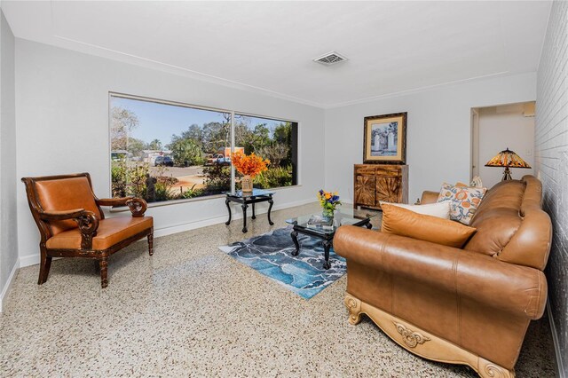 sitting room with visible vents, baseboards, and speckled floor