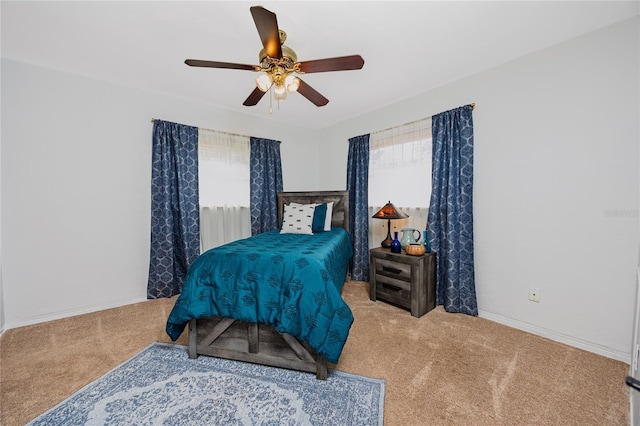 bedroom featuring ceiling fan, carpet floors, and baseboards