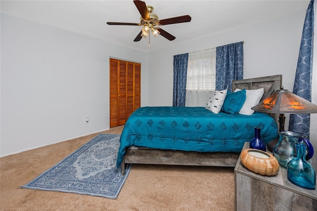 carpeted bedroom featuring a closet and ceiling fan