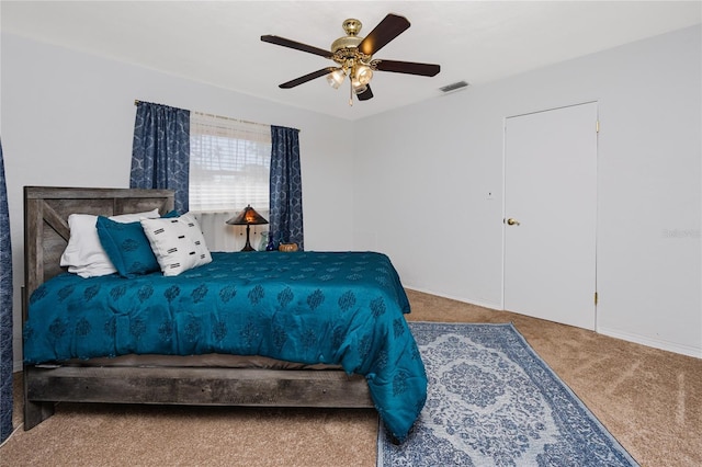 carpeted bedroom with visible vents and ceiling fan