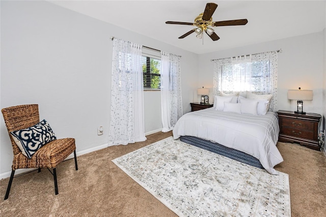 carpeted bedroom featuring ceiling fan and baseboards