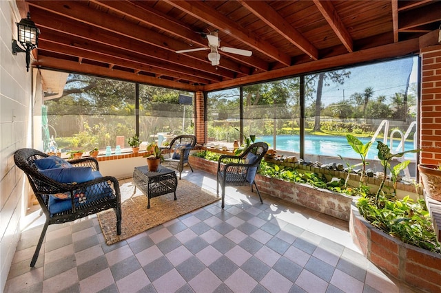 sunroom / solarium with wood ceiling, ceiling fan, and beamed ceiling