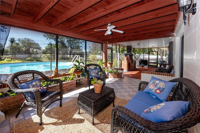 sunroom featuring wooden ceiling, ceiling fan, and beamed ceiling