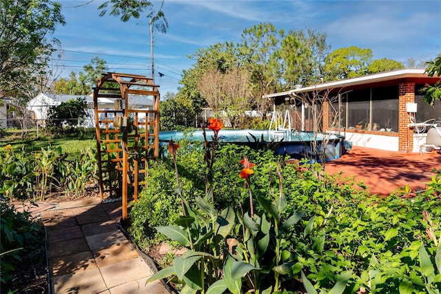 view of yard with fence and an outdoor pool