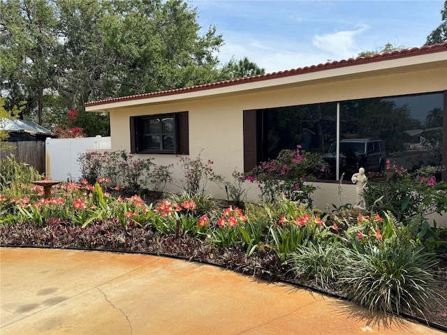 6226 Hampton Ct N, Saint Petersburg, FL 33710 - exterior space featuring stucco siding, a tile roof, fence, and a patio area