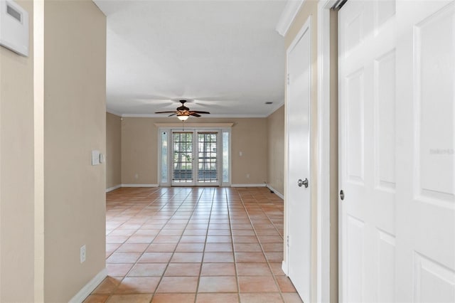 empty room with ornamental molding, light tile patterned floors, and ceiling fan