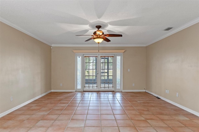 unfurnished room featuring light tile patterned floors, ornamental molding, french doors, and a textured ceiling