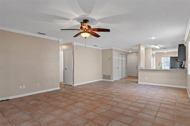 unfurnished living room with sink, crown molding, light tile patterned floors, ceiling fan, and a textured ceiling