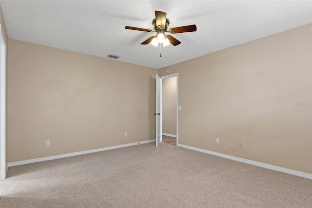 unfurnished room with ceiling fan, carpet floors, and a textured ceiling