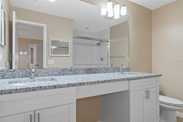 bathroom featuring walk in shower, vanity, and toilet