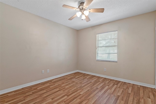 empty room with ceiling fan, a textured ceiling, and light hardwood / wood-style floors