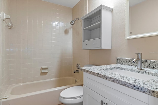 full bathroom with vanity, tiled shower / bath, and toilet