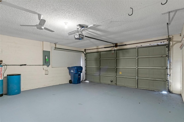 garage with a garage door opener and electric panel