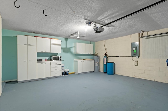 garage with water heater, a garage door opener, and electric panel