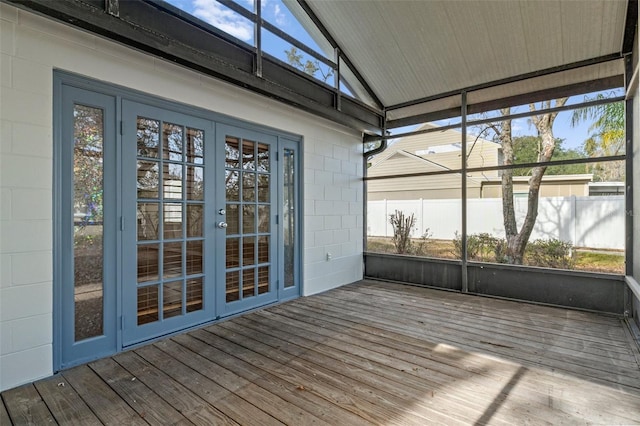 unfurnished sunroom with vaulted ceiling and french doors