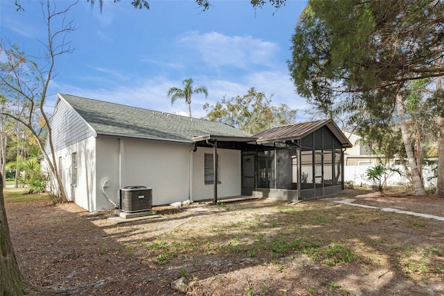 rear view of house with a sunroom and central air condition unit