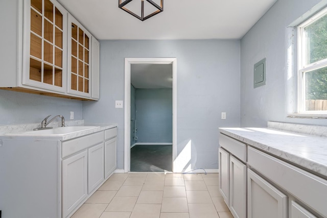 kitchen with white cabinets, sink, and a wealth of natural light