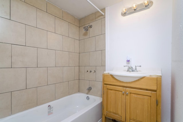 bathroom with tiled shower / bath and vanity