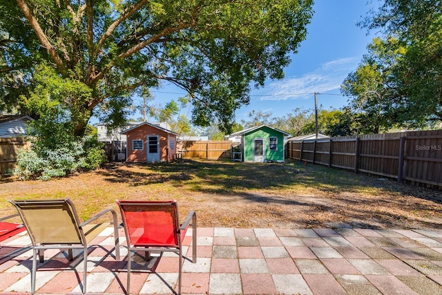 view of yard with a storage unit and a patio