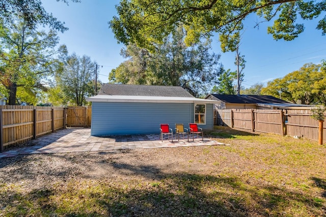 rear view of property with a patio and a yard