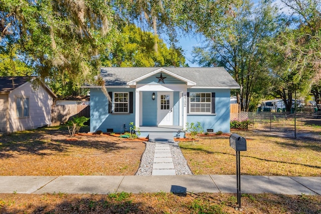 bungalow-style home featuring a front yard