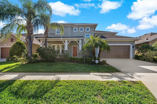 view of front of home with a garage and a front yard