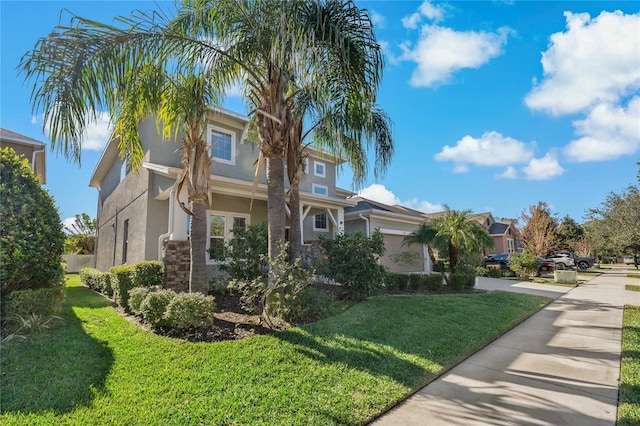 view of front of home with a garage and a front lawn