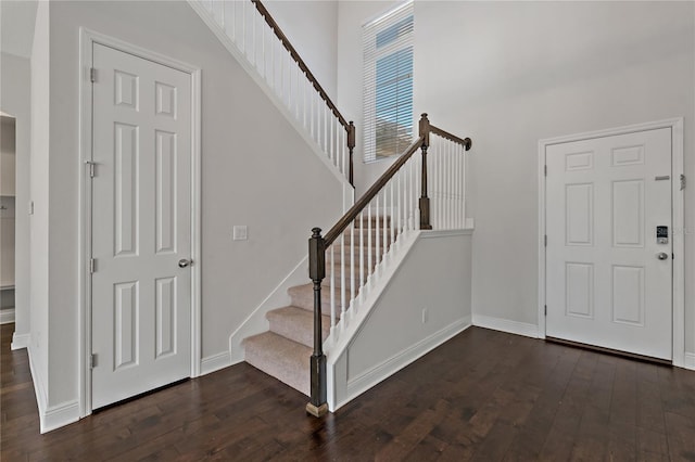 entrance foyer featuring dark hardwood / wood-style floors and a high ceiling