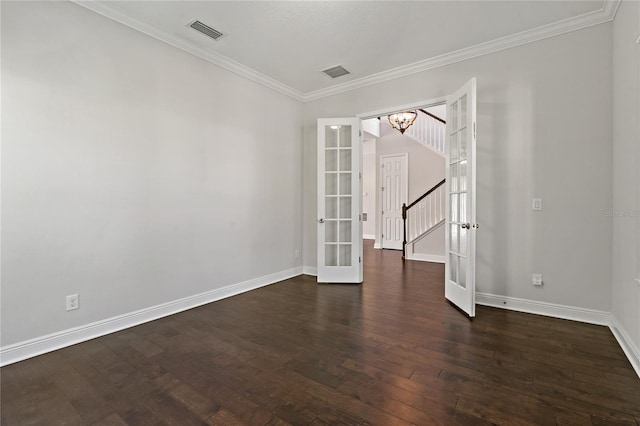 empty room with crown molding, dark wood-type flooring, and french doors