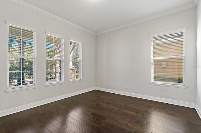 empty room with a wealth of natural light, ornamental molding, and dark hardwood / wood-style floors