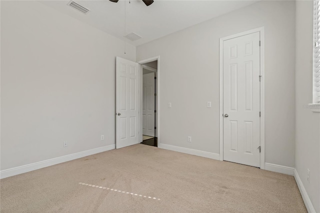 unfurnished bedroom featuring light colored carpet and ceiling fan