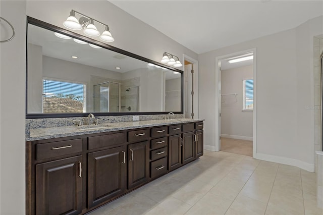 bathroom featuring walk in shower, vanity, and tile patterned flooring