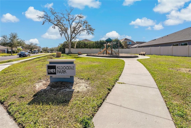 surrounding community featuring a playground and a yard