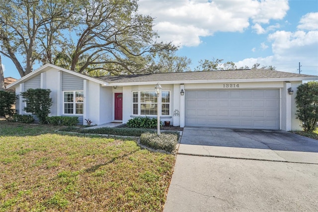 ranch-style home featuring a garage and a front lawn